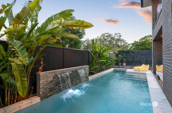 Residential property with landscaped pool area showing the importance of regular property maintenance